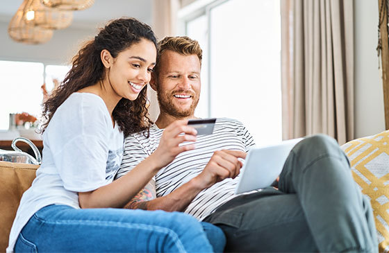 Young couple admire their platinum credit card.