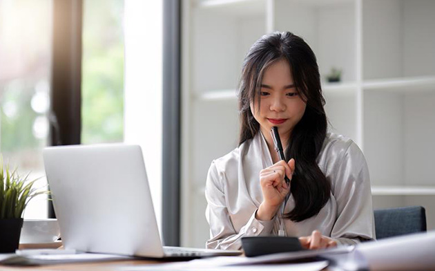 Young woman with laptop and calculator