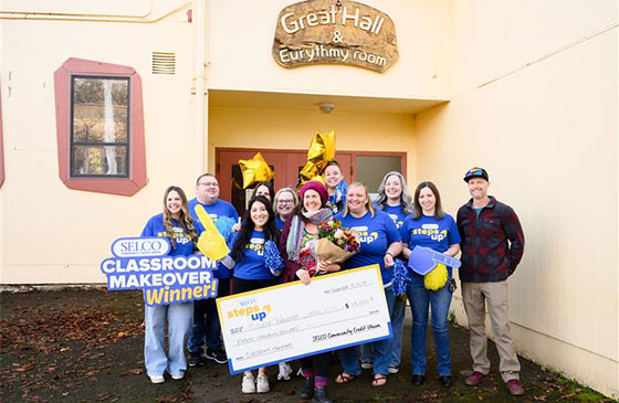 2025 classroom makeover recipient holding a check. 