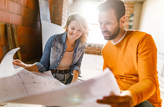 Couple looks over the plans to remodel their home.