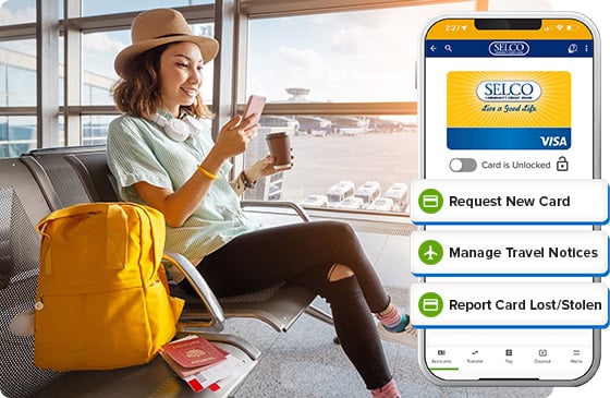 Person at airport looking at checking account using phone