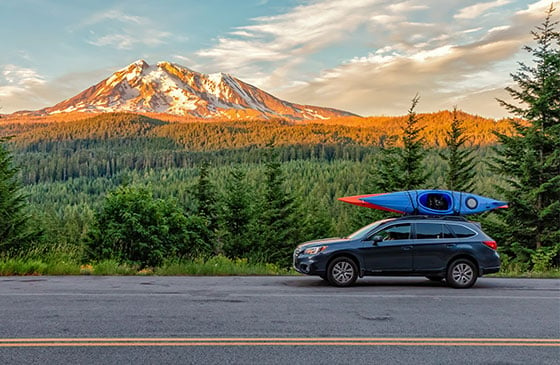 New car with kayak sitting on top