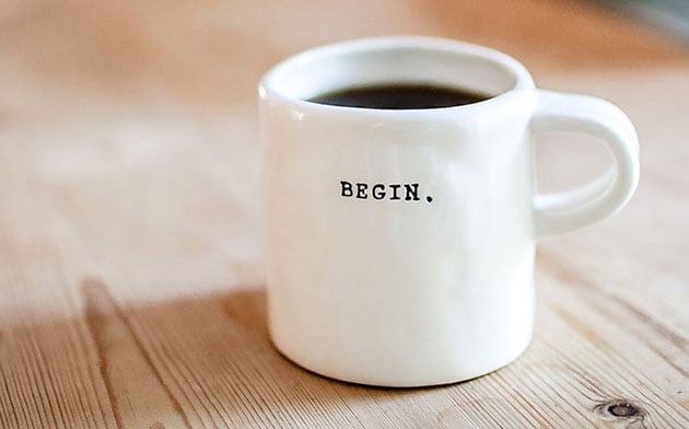 Mug full of coffee on a table. 