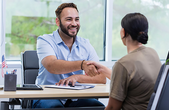 Woman speaking with a SELCO representative to become a member. 