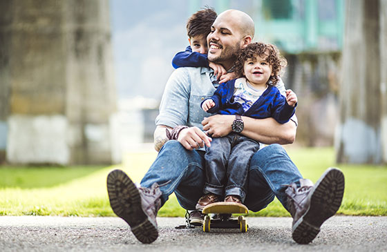 Man riding skateboard with children