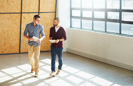 Two people looking at a commercial business space