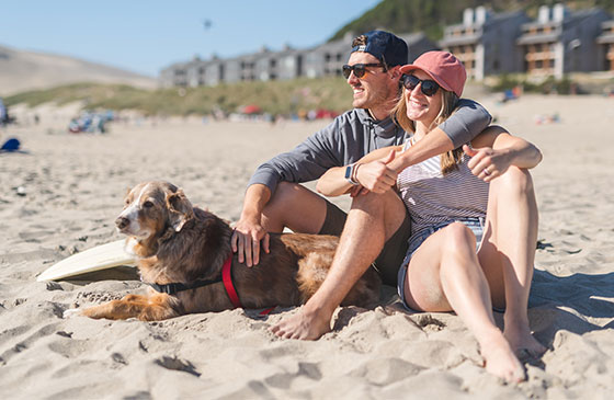 Young couple with dog at the beach