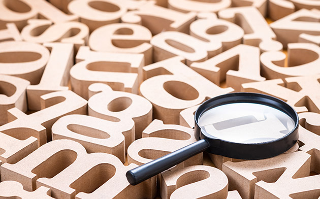 Magnifying glass and wooden letters