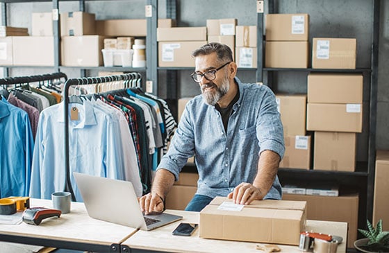 Shipping facility business owner working inside shop