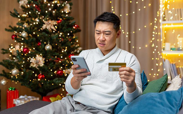 Man holding card and phone