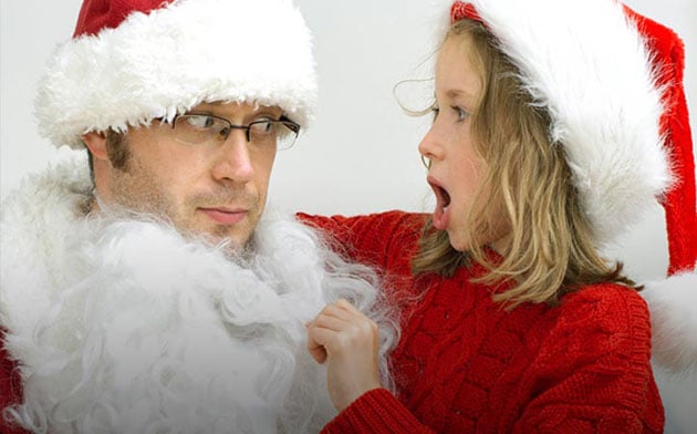 Young girl surprised that santa clause is her father. 