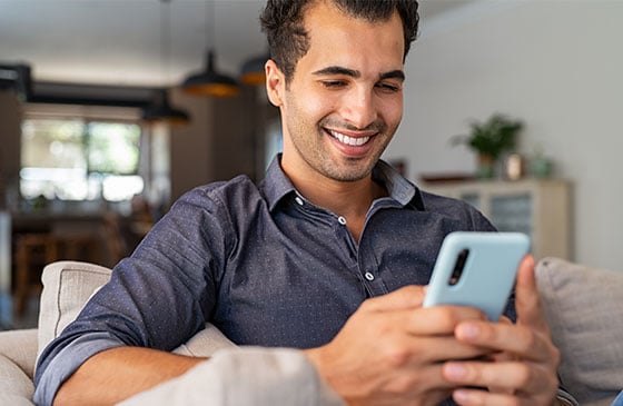 Younger man using phone to check account balance