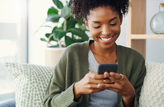 Woman checking her SELCO bank account and noticing she got paid two days earlier with early deposit access. 