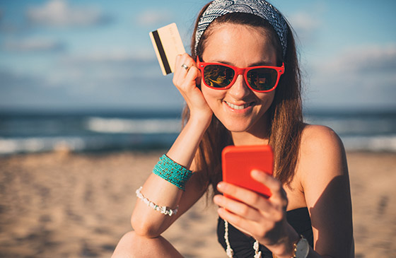 Young teen using phone to review checking account balance 