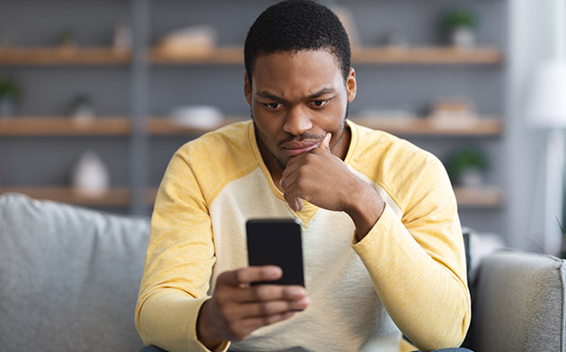 Concerned man looking at phone