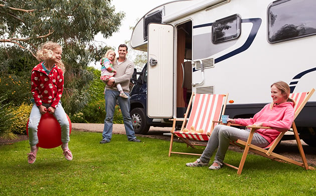 Family having fun near camper