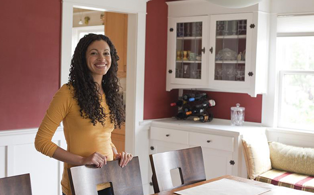 Woman standing behind table