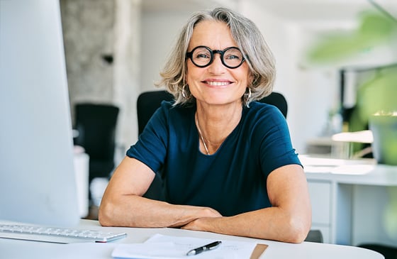 Older woman sitting in front of her computer.