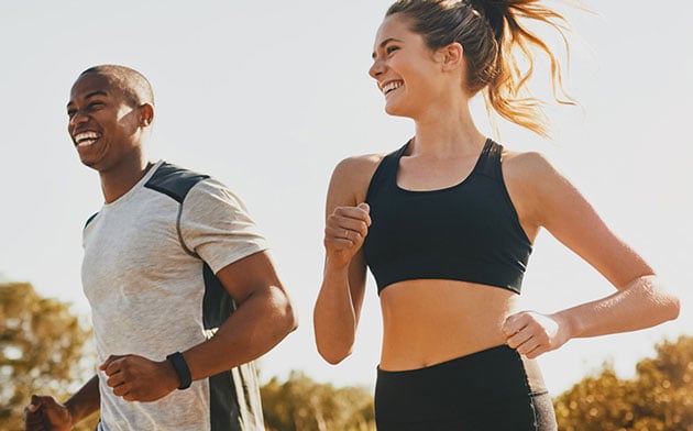 Two People Running Together Outside