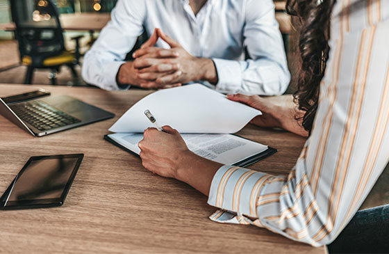 Person signing paperwork for a business loan