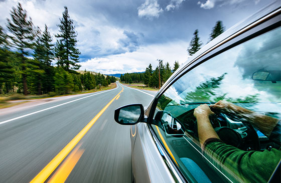 Car drives down the interstate at a high speed.